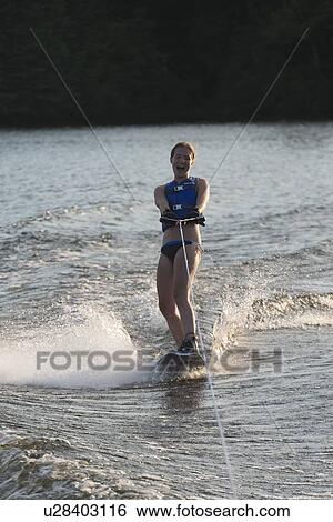 Stock Photograph - Woman waterskiing in a lake, Lake of The Woods, Keewatin, Ontario, Canada. Fotosearch