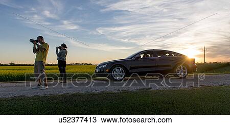 Young couple taking pictures along a prairie road, Manitoba, Canada View Large Photo Image Stock Image - Young couple taking pictures along a prairie road, Manitoba, Canada. Fotosearch