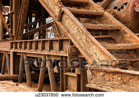 Stock Image - Abandoned rusty oil rig on Skeleton Coast, detail of corroded open staircase waysNamibia, South West Africa. Fotosearch