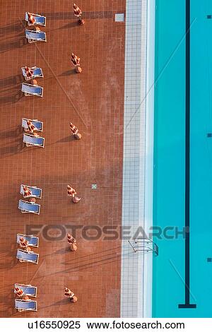 Aerial view of athlete's swimming pool with channels marked by black lines, and red and white dividers, with blue deck chairs on red tiles alongside, detail view, early morning sunshine, Umbria, Italy View Large Photo Image Stock Photography - Aerial view of athlete's swimming pool with channels marked by black lines, and red and white dividers, with blue deck chairs on red tiles alongside, detail view, early morning sunshine, Umbria, Italy. Fotosearch