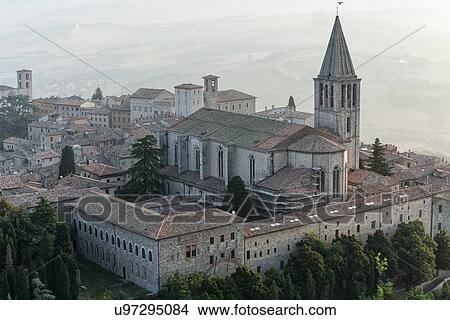 Aerial view of church and spire of San Fortunato church with cloister complex surrounding, Piazza del Popolo beyond, in medieval city of Todi in early morning hazy sunshine, Todi, Umbria, Italy View Large Photo Image Picture - Aerial view of church and spire of San Fortunato church with cloister complex surrounding, Piazza del Popolo beyond, in medieval city of Todi in early morning hazy sunshine, Todi, Umbria, Italy. Fotosearch