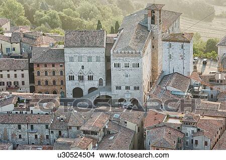 Aerial view of medieval city of Todi: Palazzo del Popolo and Palazzo del Capitano in Piazza del Popolo, in early morning hazy sunshine, Todi, Umbria, Italy View Large Photo Image Picture - Aerial view of medieval city of Todi: Palazzo del Popolo and Palazzo del Capitano in Piazza del Popolo, in early morning hazy sunshine, Todi, Umbria, Italy. Fotosearch