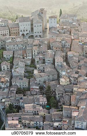 Aerial view of medieval city of Todi: Palazzo del Popolo and Palazzo del Capitano in Piazza del Popolo, in early morning hazy sunshine, Todi, Umbria, Italy View Large Photo Image Stock Photo - Aerial view of medieval city of Todi: Palazzo del Popolo and Palazzo del Capitano in Piazza del Popolo, in early morning hazy sunshine, Todi, Umbria, Italy. Fotosearch