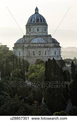 Aerial view of Santa Maria della Consolazione Tempio Church outside Todi, with surrounding trees and buildings in early morning hazy sunlight, Middle Tiber Valley, Umbria, Italy View Large Photo Image Stock Image - Aerial view of Santa Maria della Consolazione Tempio Church outside Todi, with surrounding trees and buildings in early morning hazy sunlight, Middle Tiber Valley, Umbria, Italy. Fotosearch