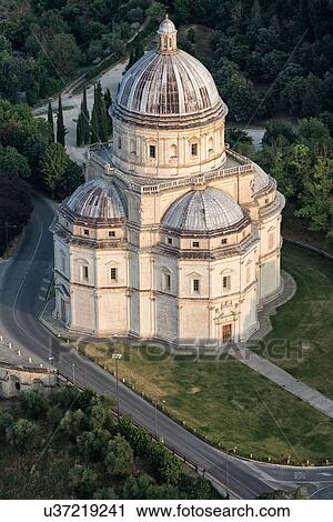 Aerial view of Santa Maria della Consolazione Tempio Church outside Todi, with surrounding trees and buildings in early morning sunlight, Middle Tiber Valley, Umbria, Italy View Large Photo Image Stock Image - Aerial view of Santa Maria della Consolazione Tempio Church outside Todi, with surrounding trees and buildings in early morning sunlight, Middle Tiber Valley, Umbria, Italy. Fotosearch