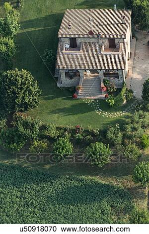 Aerial view of stone farm house surrounded by manicured lawn, trees and sunflower field in foreground in early morning sunshine, Umbria, Italy View Large Photo Image Stock Image - Aerial view of stone farm house surrounded by manicured lawn, trees and sunflower field in foreground in early morning sunshine, Umbria, Italy. Fotosearch