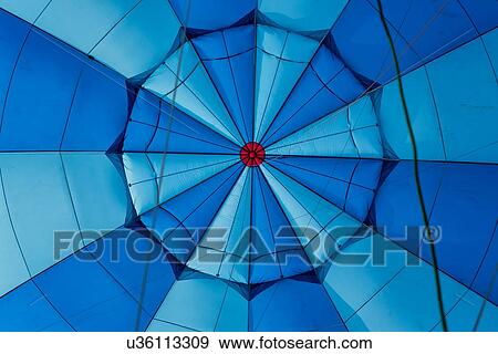 Stock Photo - Close up of interior of red, blue and navy blue hot air balloon envelope inflated, Todi Mongolfiere Hot Air Balloon Festival, Italy. Fotosearch