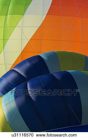 Close up of multicoloured hot air balloons inflated and about to launch with colourful overlap of patterned envelopes, Todi Mongolfiere Hot Air Balloon Festival, Umbria, Italy View Large Photo Image Stock Image - Close up of multicoloured hot air balloons inflated and about to launch with colourful overlap of patterned envelopes, Todi Mongolfiere Hot Air Balloon Festival, Umbria, Italy. Fotosearch