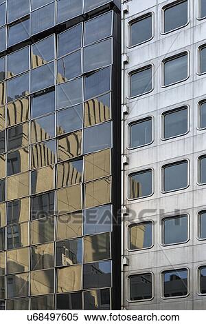 Stock Photography - Ginza district pattern detail of modern high rise buildings with one silver building reflecting another gold coloured building opposite in myriad of square windows, Tokyo, Japan. Fotosearch