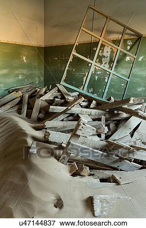 Kolmanskop interior view of room: window frame and rubble lying on top of sand dune which fills the room, abandoned German mining town, Namib desert, Namibia, South West Africa View Large Photo Image Stock Photo - Kolmanskop interior view of room: window frame and rubble lying on top of sand dune which fills the room, abandoned German mining town, Namib desert, Namibia, South West Africa. Fotosearch