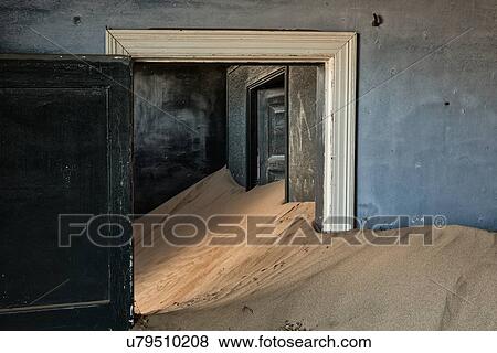 Kolmanskop interior view of room: doorway with blue painted walls, leading to other rooms and sand dune which fills the room, abandoned German mining town, Namib desert, Namibia, South West Africa View Large Photo Image Stock Photo - Kolmanskop interior view of room: doorway with blue painted walls, leading to other rooms and sand dune which fills the room, abandoned German mining town, Namib desert, Namibia, South West Africa. Fotosearch