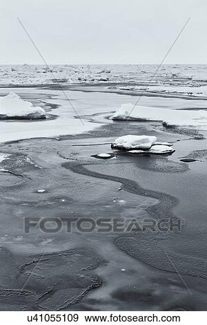 Rocks covered with snow and ice patches forming in the frozen sea creating patterns and textures, monochrome image, Shiretoko Peninsula, Hokkaido, Japan View Large Photo Image Stock Photo - Rocks covered with snow and ice patches forming in the frozen sea creating patterns and textures, monochrome image, Shiretoko Peninsula, Hokkaido, Japan. Fotosearch