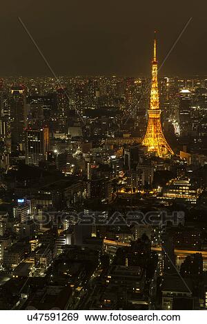Tokyo, Japan: March 2, 2013 - Tokyo Tower lit at night with modern high rise buildings also illuminated at twilight, Tokyo, Japan View Large Photo Image Stock Photo - Tokyo, Japan: March 2, 2013 - Tokyo Tower lit at night with modern high rise buildings also illuminated at twilight, Tokyo, Japan. Fotosearch