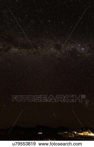 Stock Photo - View of the Milky Way, with lights of desert camp below Namib desert, Namibia, South West Africa. Fotosearch