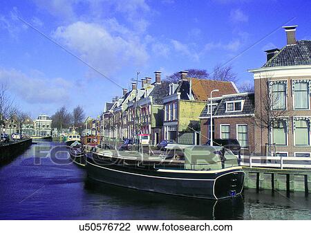 Stock Image - Blue Sky, Building Exterior, Clouds, Commercial Dock, Day. Fotosearch