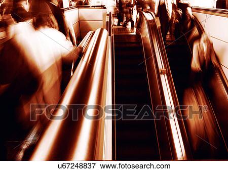 Stock Photo - Carrying, Holding, Moving Up, Escalator, Indoor. Fotosearch