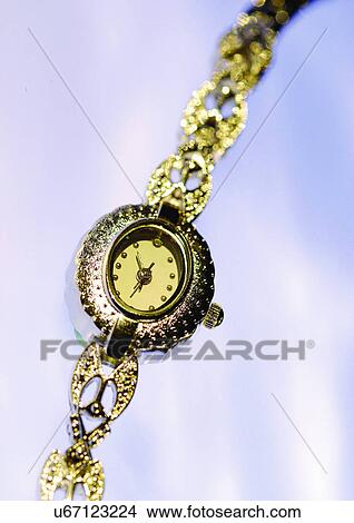 Picture - close-up, watch, golden, white background. Fotosearch