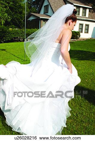 Walking, Holding, Wedding Dress View Large Photo Image Stock Photograph - Walking, Holding, Wedding Dress. Fotosearch