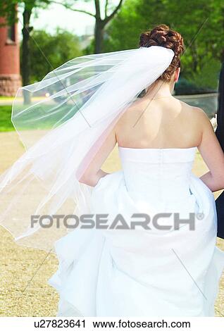 Stock Image - Walking, Wedding Dress, Veil. Fotosearch