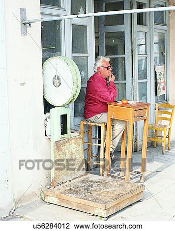 chairs, outdoors, person, storefront, building, Aegean sea View Large Photo Image Stock Image - chairs, outdoors, person, storefront, building, Aegean sea. Fotosearch