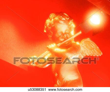 Stock Image - Christmas, indoors, lights, angel, gold. Fotosearch