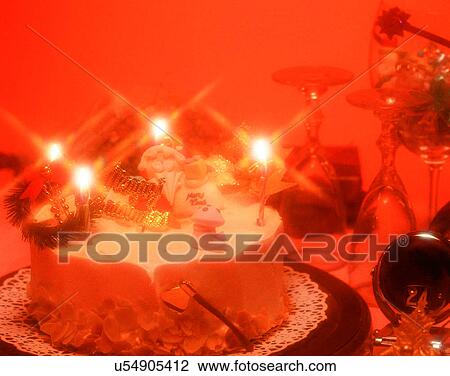 Stock Image - Christmas, indoors, party, cake, candles, wine. Fotosearch