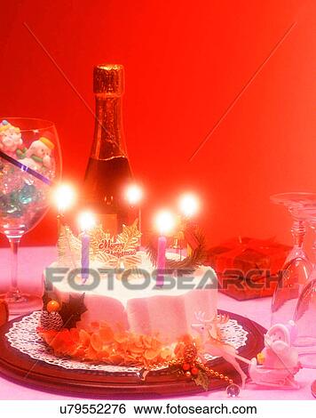 Stock Photograph - Christmas, indoors, party, cake, candles, wine. Fotosearch