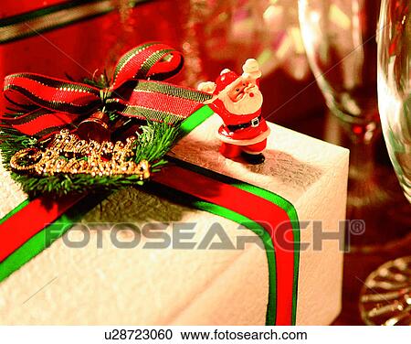Stock Image - Christmas, indoors, santa claus, miniature, gifts, wine glasses. Fotosearch