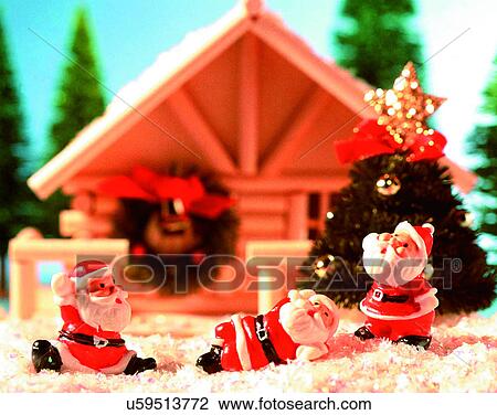 Stock Image - Christmas, indoors, santa claus, miniature, house, tree. Fotosearch