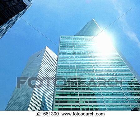 Stock Image - City view, modern look, outdoors, low angel view, sunshine, sky. Fotosearch