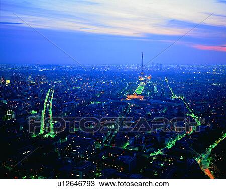 Stock Image - City view, modern look, outdoors, buildings, business, night time. Fotosearch