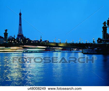 Stock Photo - City view, modern look, outdoors, buildings, night time, lights. Fotosearch