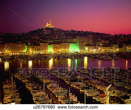 Stock Image - City view, outdoors, night time, lights, sky, water front. Fotosearch