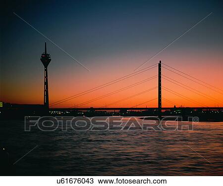 Stock Image - City view, outdoors, night time, lights, sky, water front. Fotosearch