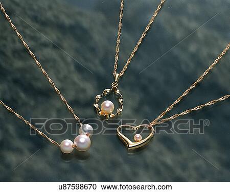 Stock Image - close-up, jewelry, luxury, marble, gold, necklaces. Fotosearch