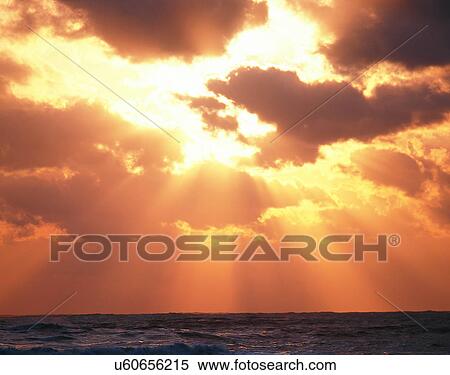 Stock Photography - clouds, sky, outdoors, sunset, rays, water. Fotosearch
