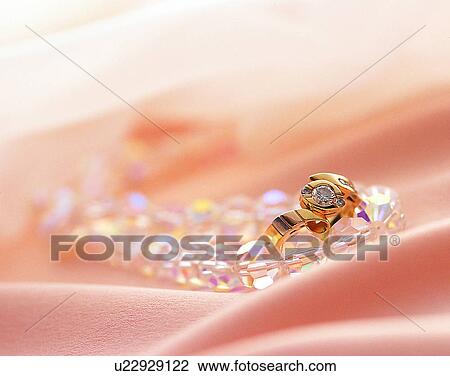 Stock Image - Color images, close-up, jewelry, luxury, ring, gold, glass. Fotosearch
