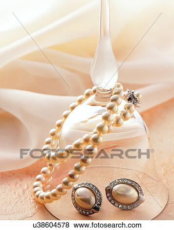 Stock Photo - Color images, close-up, jewelry, luxury, ear rings, necklace, glass. Fotosearch
