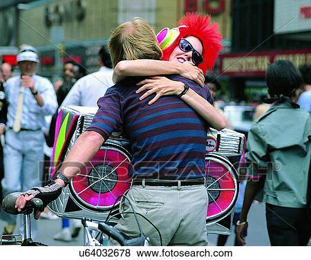 Stock Photo - companionship, friends, hugging, outdoors, city street. Fotosearch