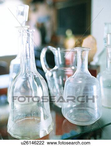 Stock Image - Europe, glasses, bottles, jars, shelf. Fotosearch