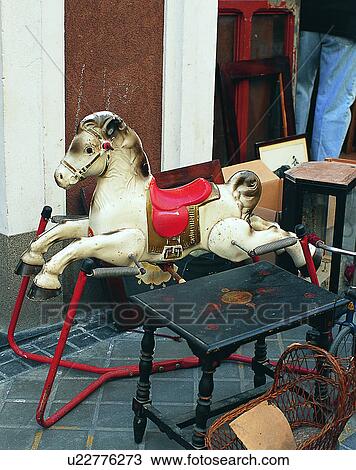 Stock Image - Europe, indoors, junk, old, rocking horse, table. Fotosearch
