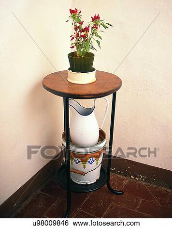 Stock Photograph - Europe, indoors, table, flower pot, flower, pitcher. Fotosearch