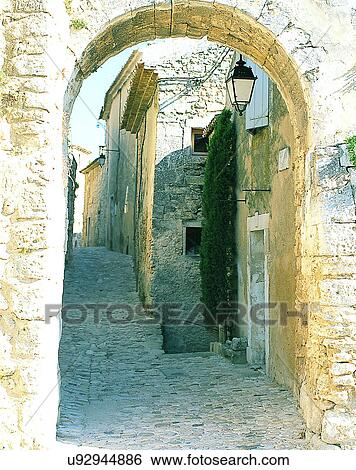 Stock Photograph - Europe, outdoors, streets, alley, arch, lamp. Fotosearch