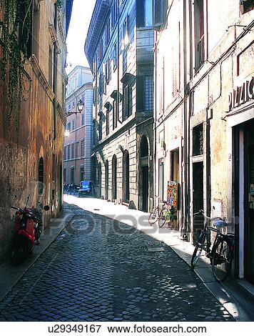 Stock Photo - Europe, outdoors, streets, alley, shadows, bikes. Fotosearch