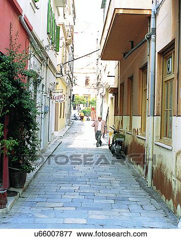 Stock Photo - Europe, outdoors, streets, alley, people, scooter. Fotosearch