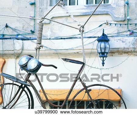 Stock Image - Europe, outside, bike, headlights, rope, building. Fotosearch