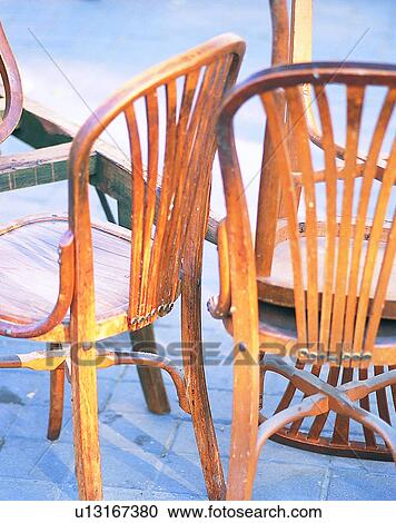 Stock Image - Europe, outside, chairs, wood, shadows. Fotosearch