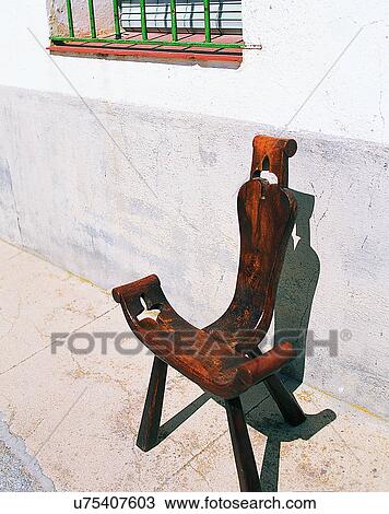 Stock Image - Europe, outside, traditional design, chair, wall, window. Fotosearch
