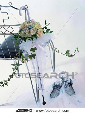 Stock Image - indoors, bouquet, flowers, close-up, chair, leaves. Fotosearch
