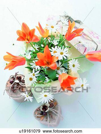 Stock Photo - indoors, bouquet, flowers, close-up, orange, gifts. Fotosearch